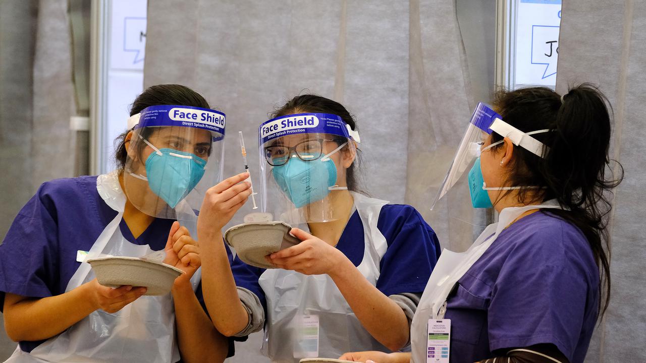 Nursing staff at the mass vaccination hub at Western Health - Melbourne Showgrounds in Ascot Vale.