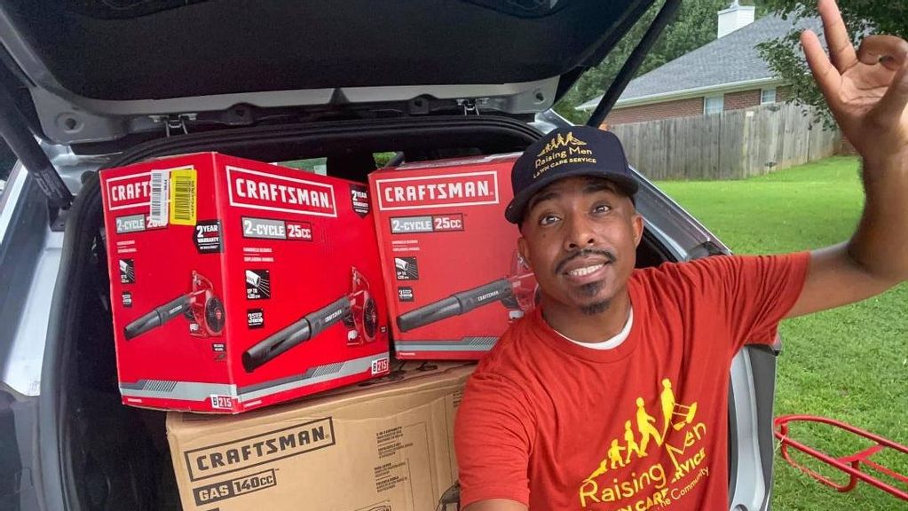 Rodney Smith Jr. with “50 Yard Challenge” winners' lawn mowers and blowers. (Courtesy of Rodney Smith Jr.)