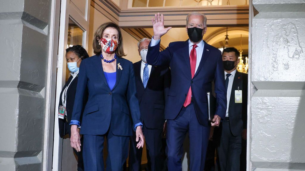 House Speaker Nancy P. Pelosi (D-Calif.) arrives with U.S. President Joseph R. Biden Jr. to meet with House Democrats at the Capitol Building in Washington, D.C., on Oct. 1. Biden called the session to try to overcome an impasse over his spending plans. (Kevin Dietsch/Getty Images)