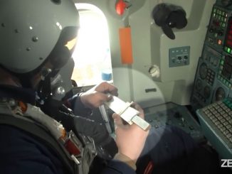 Aboard a Russian Tupolev Tu-160 strategic bomber, a crew member appears to operate a slide rule for a calculation. The incident took place on Nov. 11 during a joint mission with the Belarusian Air Force. (Russian Ministry of Defense/Zenger)