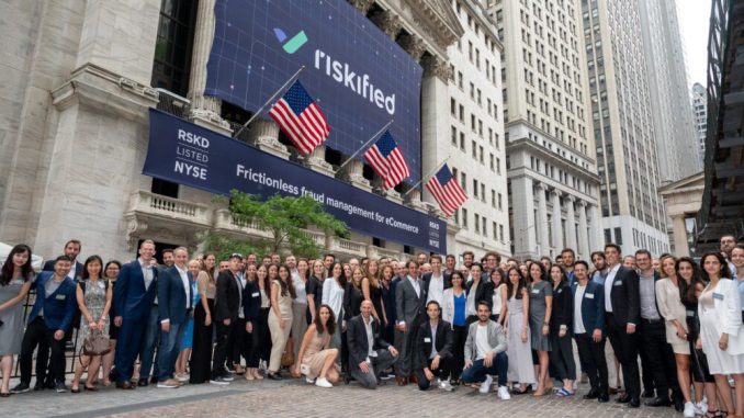 Riskified employees in front of the New York Stock Exchange. Riskified, which went public last July, works with clients including Acer, Trip.com and Ticketmaster. (CRC Media)