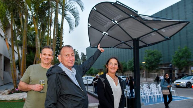 Tel Aviv-Yafo Mayor Ron Huldai, center, flanked by LumiWeave CEO and cofounder Tal Parnes and LumiWeave inventor Anai Green at the installation of LumiWeave in Atidim Park. (Tel Aviv Global & Tourism)