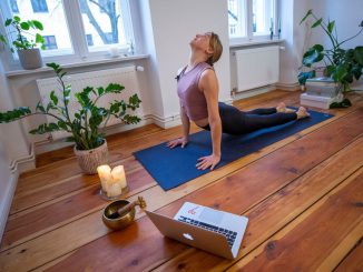 Marlene of Yoga on the Move Berlin warms up prior online stream session in her home on March 25, 2020 in Berlin, Germany. Small businesses are trying ways of offering services for clients in the midst of the COVID-19 pandemic. (Photo by Maja Hitij/Getty Images)