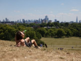 A man drinks a beer on Primrose Hill on July 10, 2022 in London, England. (Photo by Hollie Adams/Getty Images)