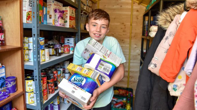 Isaac Winfield, 11, has set up his own food bank at his home. (Photo by Emma Trimble via SWNS)