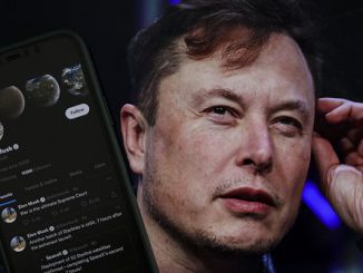 Elon Musk's Twitter profile is on a mobile phone and his image is on a computer screen on back of it in Ankara, Turkiye, on October 06, 2022. 180 organizations have urged Twitter to adopt the IHRA definition of antisemitism. MUHAMMED SELIM KORKUTATA/ANADOLU AGENCY VIA GETTY IMAGES
