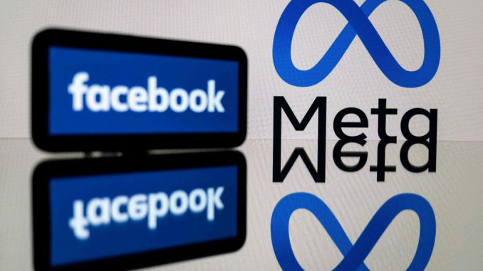 strongThis picture taken on Jan. 12, 2023 in Toulouse, southwestern France shows a smartphone and a computer screen displaying the logos of the social network Facebook and its parent company Meta. LIONEL BONAVENTURE/AFP/GETTY IMAGES/strong