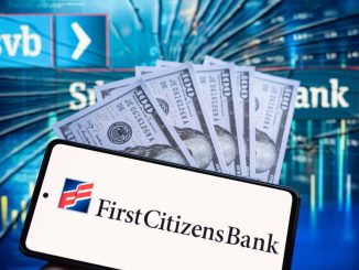 First Citizens Bank logo displayed on mobile with Silicon Valley Bank seen in the background. First Citizens Banks agreed to buy Silicon Valley Bank where Jeff Ransdell still banks. JONATHAN RAA/BENZINGA