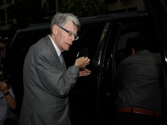US author Stephen King takes his mask off before entering a vehicle as he departs the US District Court in Washington, DC, on August 2, 2022. - King has called Twitter ‘very strange’ amid the take-over by Elon Musk. MANDEL NGAN/BENZINGA