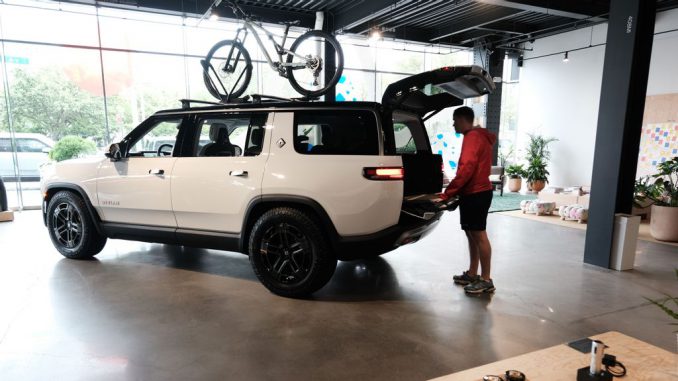 NEW YORK, NEW YORK - JUNE 23: Taylor looks at Rivian electric trucks at the auto maker's newly opened storefront in the Meatpacking District of Manhattan on June 23, 2023 in New York City. The 5,000-square-foot location, Rivian’s first on the East Coast, displays its R1T and R1S electric vehicles and offers merchandise, test drives and a lounge and activity space for children. The Manhattan showroom is a temporary location until Rivian opens its permanent New York location in Brooklyn’s trendy Williamsburg neighborhood. (Spencer Platt/Getty Images)