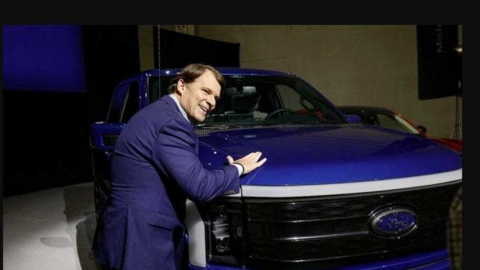 Ford CEO Jim Farley poses with a Ford F-150 Lightning truck. During his journey, Farley made a notable stop at a 350 kW charger in Baker, California, expressing his enthusiasm for the quick and easy charging experience. BILL PUGLIANO VIA GETTY IMAGES.