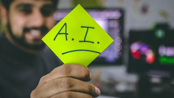 A young tech worker holding a sign of “A.I.” Vice President Kamala Harris voiced her support for AI at a summit in the UK. (HITESH CHOUDHARY/UNSPLASHED)