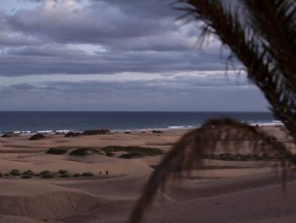 People walk through the sand dunes at sunset on Dec. 5, 2020, in Maspalomas, Spain. The dunes at Maspalomas saw a positive transformation during the Coronavirus pandemic due to the lack of tourism on the island. Conservation efforts over several years to restore the natural habitat have had a boost due to the lack of disturbance, as many of the dunes have regained their shape and height, and vegetation has started to recover. (Dan Kitwood/Getty Images)