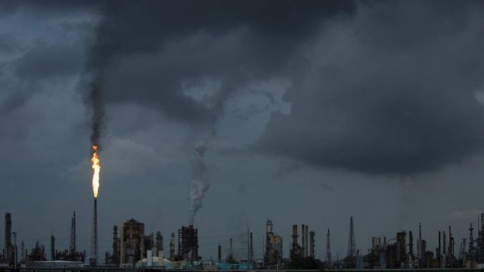 A gas flare from the Shell Chemical LP petroleum refinery illuminates the sky on August 21, 2019, in Norco, Louisiana. Located about 10 miles up the Mississippi River from New Orleans, the plant agreed to install $10 million in pollution monitoring and control equipment in 2018 to settle allegations that flares used to burn off emissions were operating in violation of the Clean Air Act. (Drew Angerer/Getty Images)