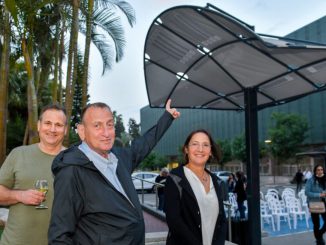 Tel Aviv-Yafo Mayor Ron Huldai, center, flanked by LumiWeave CEO and cofounder Tal Parnes and LumiWeave inventor Anai Green at the installation of LumiWeave in Atidim Park. (Tel Aviv Global & Tourism)