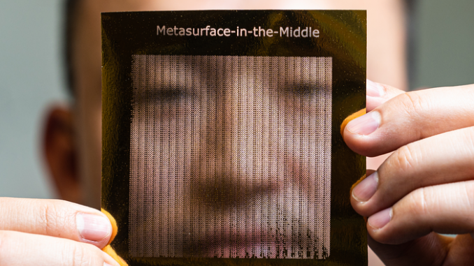 Rice University graduate student Zhambyl Shaikhanov holds a foil sheet he used to create a “metasurface” — a paper sheet covered with a 2D foil pattern — that an eavesdropper could use in a “Metasurface-in-the-Middle” attack to redirect part of a high-frequency “pencil beam” transmission like those planned for 6G wireless networks.(Jeff Fitlow/Rice University)