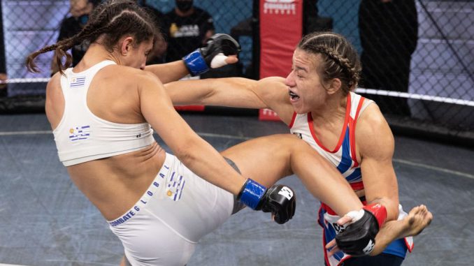 Caroline “Taz Gallardo dodges a leg kick to strike Camila Rivarola in their recent Combate Global women's bout in Miami.  (Scott Hirano/Combate Global)