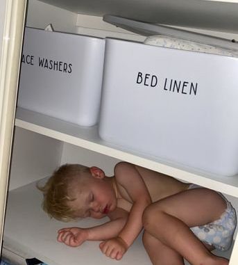 Meet the tot who will fall asleep anywhere but his own cot - including in his wardrobe, on a shelf and even on his pet dog. (Kate Johnston, SWNS/Zenger)