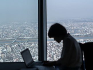A cafe employee works on her laptop on the viewing platform of the Tokyo Skytree on March 29, 2018 in Tokyo, Japan.  (Photo by Carl Court/Getty Images)