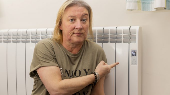 Sam Newland, 50, shows that each radiator in the house is set to 30 degrees on February 25, 2022. Newland is allergic to both cold and hot temperatures and has to have her heating on a constant 30 degrees in winter. (Leila Coker, SWNS/Zenger)