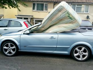 A mattress improperly stuffed in the front seat of a car, in undated photo. Drivers from around the United Kingdom lately have been driving the police crazy. (WMP,SWNS.com/Zenger)
