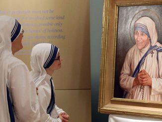 Sisters of the Missionaries of Charity look at the official canonization portrait of Mother Teresa, during a portrait unveiling ceremony at The Saint John Paul II National Shrine, Sept. 1, 2016, in Washington, DC. Mother Teresa was a Albanian nun who founded the Missionaries of Charity religious order to care for the poor in India and around the world. (Mark Wilson/Getty Images)