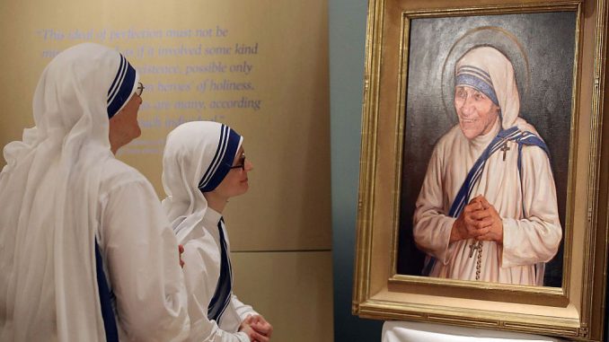 Sisters of the Missionaries of Charity look at the official canonization portrait of Mother Teresa, during a portrait unveiling ceremony at The Saint John Paul II National Shrine, Sept. 1, 2016, in Washington, DC. Mother Teresa was a Albanian nun who founded the Missionaries of Charity religious order to care for the poor in India and around the world. (Mark Wilson/Getty Images)