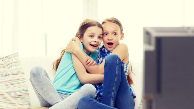 In this picture young girls react to a program on the television in this file photo. Watching violent content affects childrens performance in schools. GROUND  PICTURE VIA SHUTTERSTOCK 