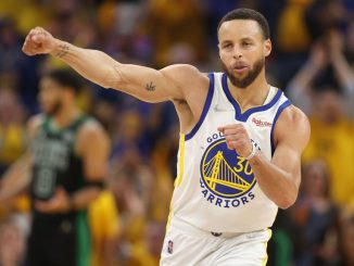 Steph Curry of the Golden State Warriors celebrates after teammate Andrew Wiggins made a basket during Game Five of the 2022 NBA Finals. Curry is one of several athletes named in a class-action FTX lawsuit for promoting the cryptocurrency platform. brEZRA SHOW/GETTY IMAGES   