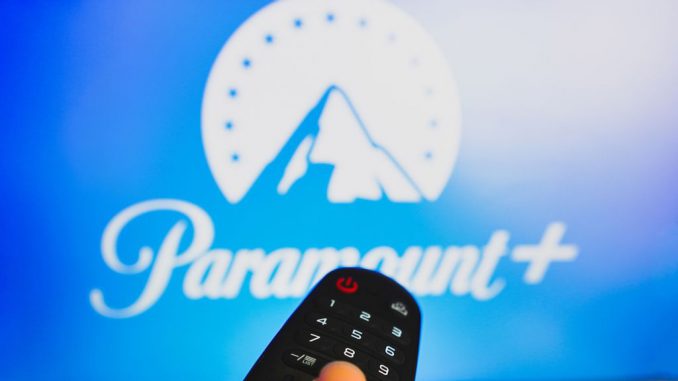 In this photo illustration, a hand holding a TV remote control in front of the Paramount Plus logo on a TV screen. Showtime had been folded into the Paramount+ premium package that is priced at $11.99 per month. RAPHAEL HENRIQUE/GETTY IMAGES