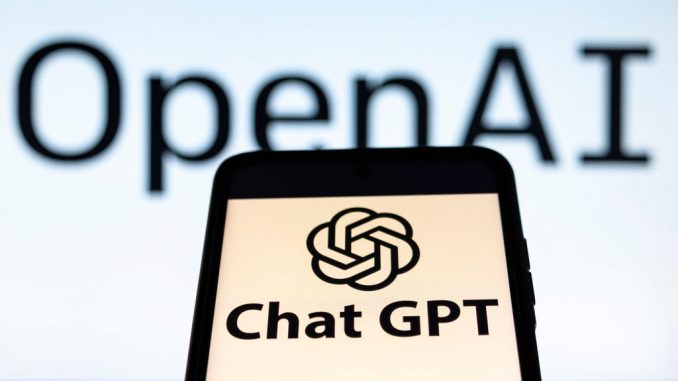 Photo illustration showing ChatGPT and OpenAI research laboratory logo and inscription at a mobile phone smartphone screen with a blurry background. Open AI is an app using artificial intelligence technology. Italy is the first European country to ban and block the robot Chat GPT application and website. ChatGPT is an artificial-intelligence (AI) chatbot developed by OpenAI and launched in November 2022 using reinforcement learning techniques both from machine and human feedback. Amsterdam, the Netherlands on April 1, 2023. NICOLAS ECONOMOU/BENZINGA