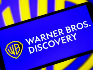 In this photo illustration, a Warner Bros. Discovery, Inc. (WBD) logo is seen on a smartphone screen. Lawmakers are calling for the Department fo Justice to investigate the merger of Warner Bros. Discovery. PAVLO GONCHAR/BENZINGA