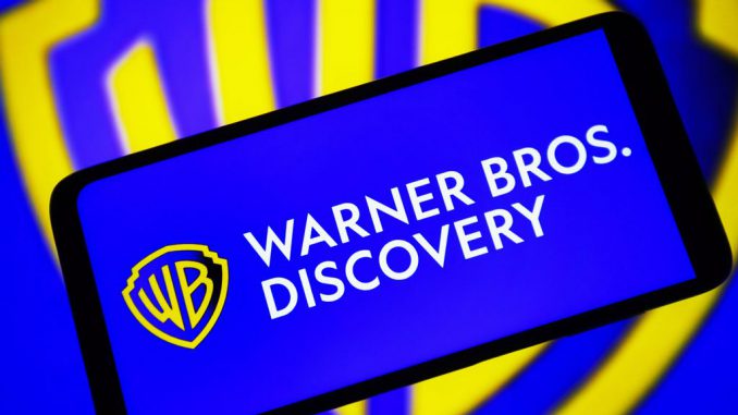 In this photo illustration, a Warner Bros. Discovery, Inc. (WBD) logo is seen on a smartphone screen. Lawmakers are calling for the Department fo Justice to investigate the merger of Warner Bros. Discovery. PAVLO GONCHAR/BENZINGA
