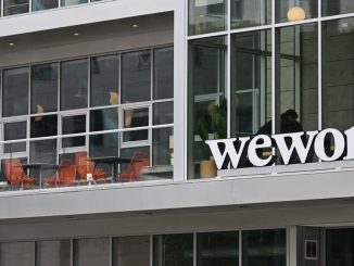 The WeWork logo is displayed outside of an office space rental location in Santa Monica, California on March 20, 2023. Sandeep Mathrani has stepped down as CEO of WeWork as May 26 will be his last day. PATRICK T. FALLON/BENZINGA