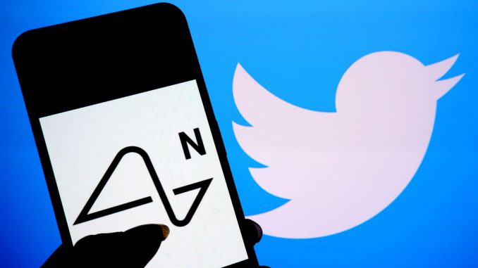 In this photo illustration, a Neuralink logo is seen displayed on a smartphone with a Twitter logo in the background. AVISHEK DAS/GETTY IMAGES
