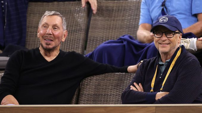 (L-R) Larry Ellison and Bill Gates watch a match between Gael Monfils of France and Alexander Zverev of Germany on Day 10 of the BNP Paribas Open at the Indian Wells Tennis Garden on October 13, 2021 in Indian Wells, California. In the recent developments, the surge in artificial intelligence (AI) has not only propelled Oracle Corp.'s (NYSE:a href=https://www.Zenger News.com/stock/ORCL#NYSEORCL/a) stock to record highs but also boosted the net worth of its founder, Larry Ellison, to unprecedented levels.  PHOTO BY SEAN M.HAFFEY/GETTY IMAGES