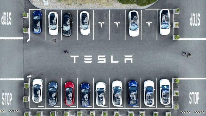 In an aerial view, Tesla cars sit parked in a lot at the Tesla factory on April 20, 2022 in Fremont, California. Tesla reported first quarter earnings that far exceeded analyst expectations with revenue of $18.76 billion compared to expectations of $17.80 billion. PHOTO BY JUSTIN SULLIVAN/GETTY IMAGES