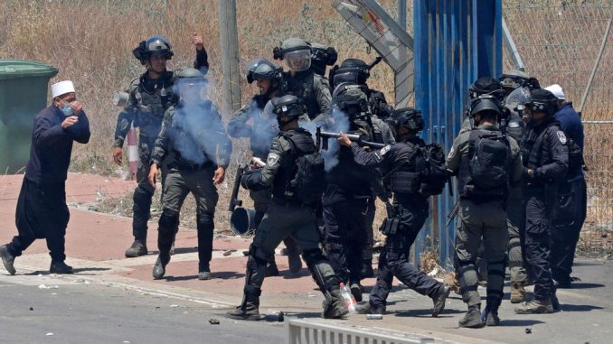 Israeli security forces clash with members of the Druze community during a protest in their village of Masada in the Israel-annexed Golan Heights on June 21, 2023, against an Israeli wind turbine project reportedly planned in the agricultural lands of the village. JALAA MAREY/AFP VIA GETTY IMAGES