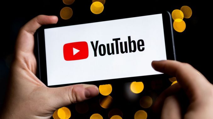 A YouTube logo seen displayed on a smartphone.YouTube has announced at VidCon, its plan to enhance the process of dubbing videos in various languages by leveraging AI technology.  MATEUSZ SLODKOWSKI/SOPA IMAGES/LIGHTROCKET VIA GETTY IMAGES.