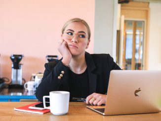 Lady deep in thought next to a laptop. For many, age 31 marks a decade of work, suggesting that workers get a ‘10-year career itch’ to switch jobs. MAGNET.ME VIA UNSPLASH