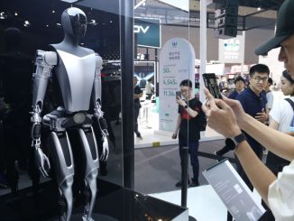 Visitors view the Tesla Bot humanoid robot of Tesla Optimus at the 2023 World Artificial Intelligence Conference in Shanghai, China, July 6, 2023. Tesla CEO strongElon Musk has /strongsaid the first Optimus bot that will have all the Tesla-designed actuators integrated and walking will be ready by around November. (CFOTO/Future Publishing via Getty Images)