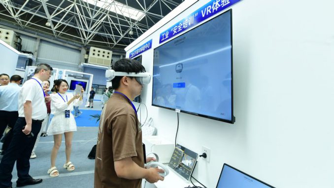 SUZHOU, CHINA - JUNE 27, 2023 - A visitor experiences in front of the industrial Safety training VR experience Center booth of a company's booth at the Meta Universe International Equipment Exhibition Hall, Suzhou, Jiangsu province, China, June 27, 2023. PHOTO BY CFOTO/GETTY IMAGES