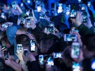 Spectators hold up mobile phones at an event on May 2, 2018 in Cardiff, United Kingdom. (MATTHEW HORWOOD/GETTY)