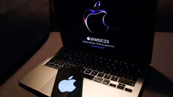 A laptop with Apple website displayed on a screen and Apple logo displayed on a phone screen are seen in this illustration photo taken in Krakow, Poland on June 5, 2023. PHOTO BY JAKUB PORZYCKI/GETTY IMAGES