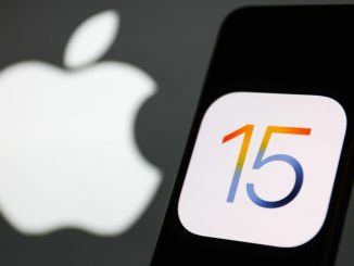 iOS 15 logo displayed on a phone screen and Apple logo in the background are seen in this illustration photo taken in Krakow, Poland. PHOTO BY JAKUB PORZYCKI/GETTY IMAGES 