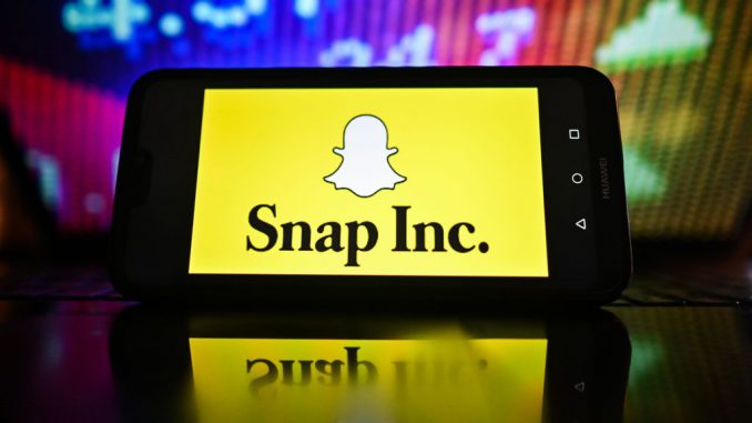 strongIn this photo illustration, a Snap Inc logo is displayed on a smartphone with stock market pricing in the background. OMAR MARQUES/SOPA IMAGES/LIGHTROCKET/GETTY IMAGES/strong