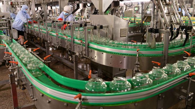 SHIJIAZHUANG, CHINA - AUGUST 02: Employees work on the production line of bottled fruit at Hebei Huaquan Foodstuffs Co., Ltd. on August 2, 2023 in Shijazhuang, Hebei Province of China. (Photo by Li Mingfa/VCG via Getty Images)