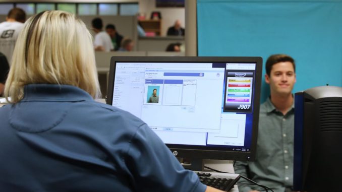 A man has his photo taken at the Driver License Division for the state of Utah in 2019 in Utah. Documents recently made public show that the FBI and Immigration and Customs Enforcement (ICE) have made thousands of searches in Department of Motor Vehicle databases using facial recognition technology in at least three states. GEORGE FREY/GETTY IMAGES.