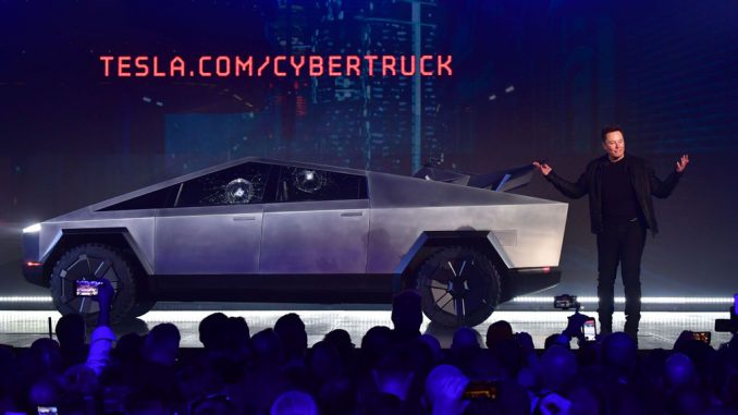 Tesla co-founder and CEO Elon Musk speaks in front of the newly unveiled all-electric battery-powered Tesla's Cybertruck with shattered windows, after a failed resistance test, at Tesla Design Center. Cybertruck, which has yet to be launched officially, has reportedly fetched $400,000 at an auction. FREDERIC J. BROWN/AFP VIA GETTY IMAGES.