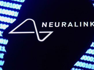 Neuralink logo displayed on a phone screen, a silhouette of a paper in shape of a human face and a binary code displayed on a screen are seen in this multiple exposure illustration photo taken in Krakow, Poland on December 10, 2021. JAKUB PORZYCKI/BENZINGA